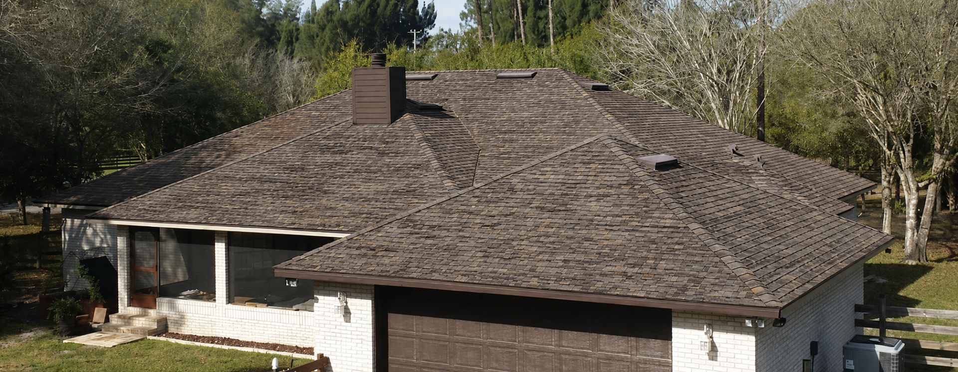 Wind-damaged shingle roof before replacement — Brevard County, FL